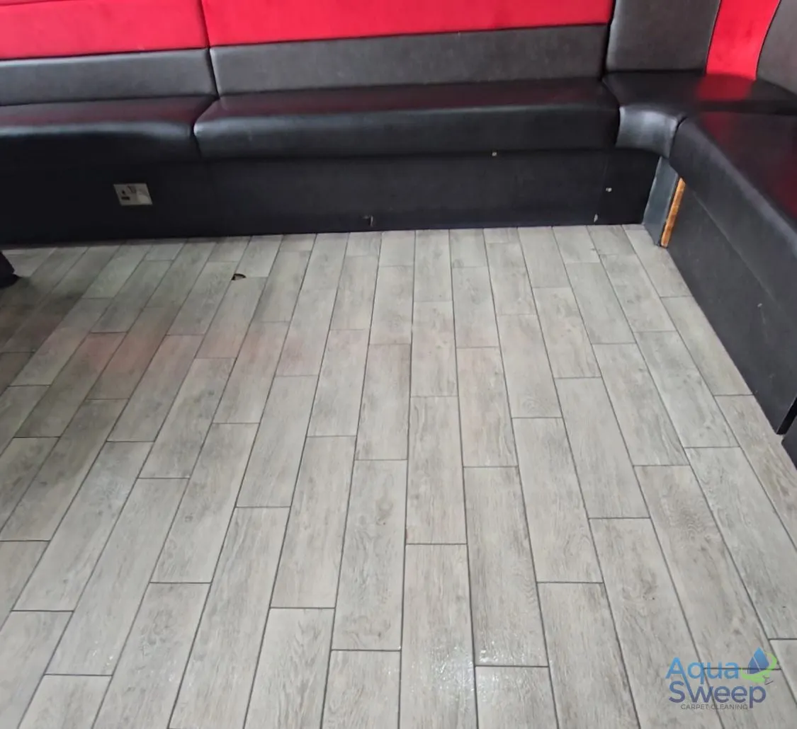 After: wood effect floor tiles in a bar seating area