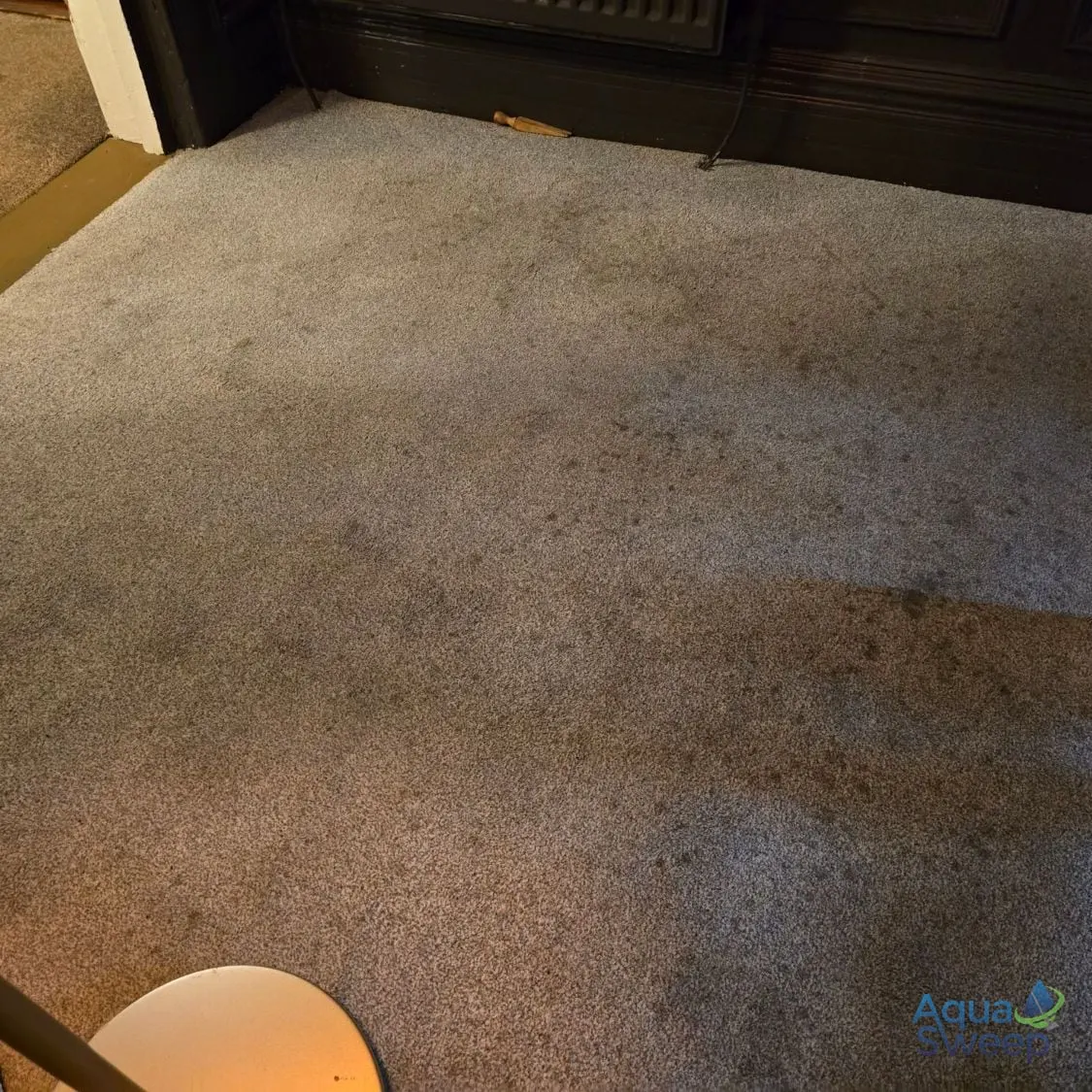 Before: light grey carpet with massage oil spots across the room