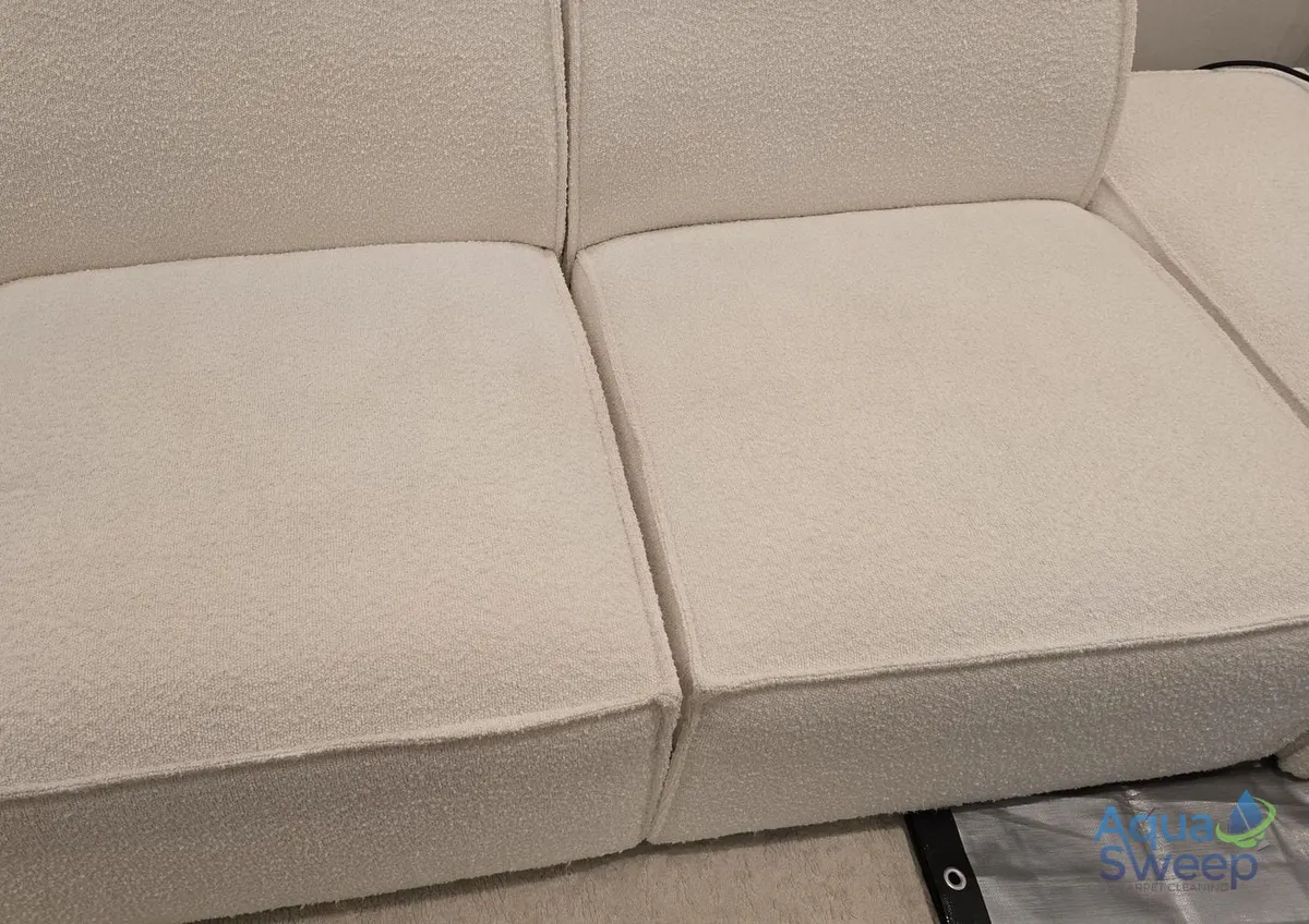 After: cream textured fabric sofa with marks on the seat cushions