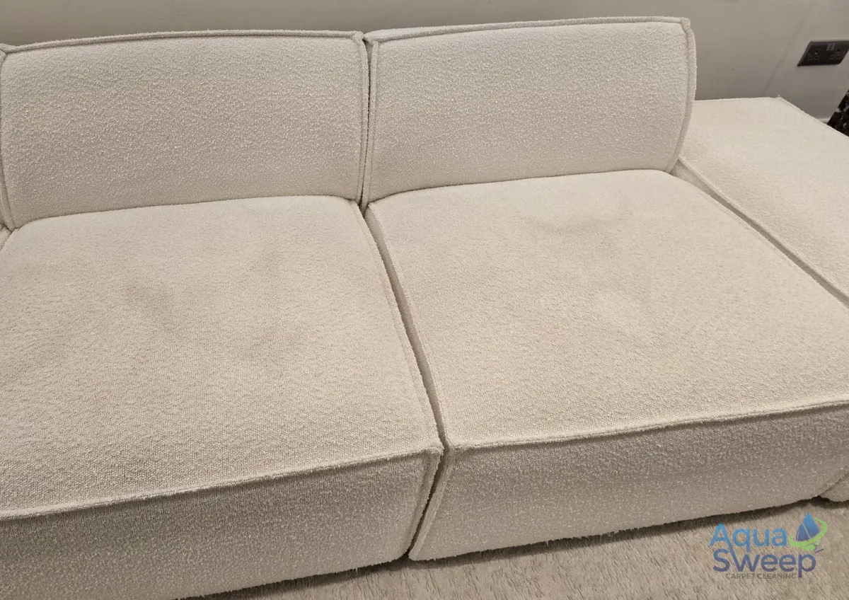 Before: cream textured fabric sofa with marks on the seat cushions
