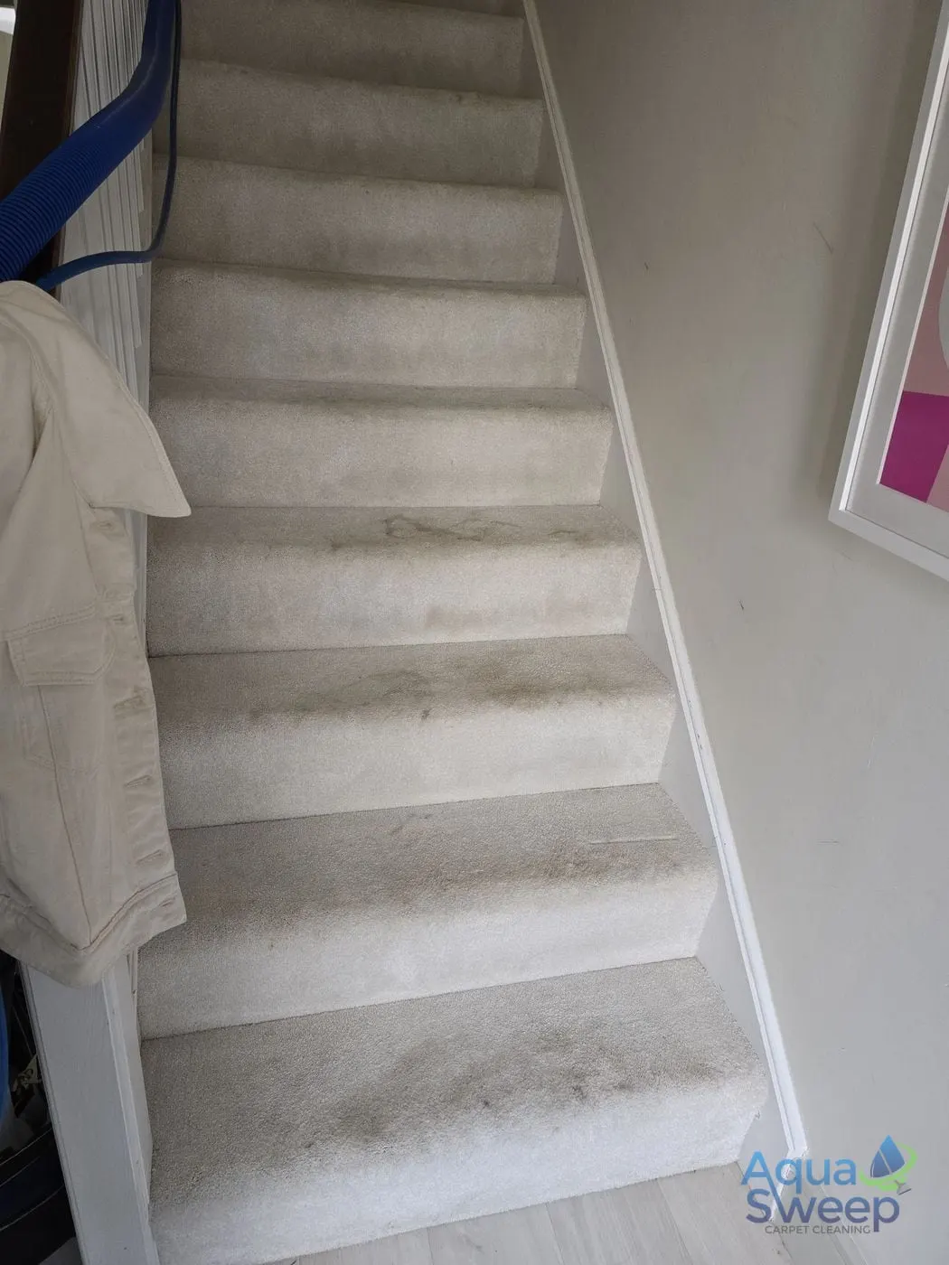 Before: cream carpeted staircase with dark marks on every step