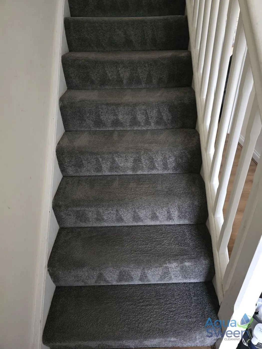 After: grey carpeted staircase with marks on the treads
