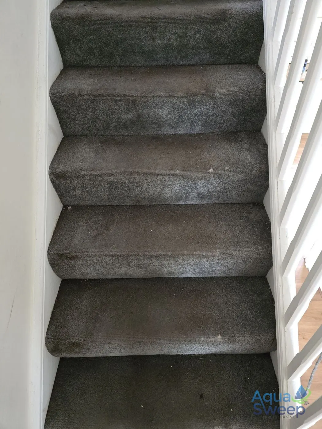 Before: grey carpeted staircase with marks on the treads