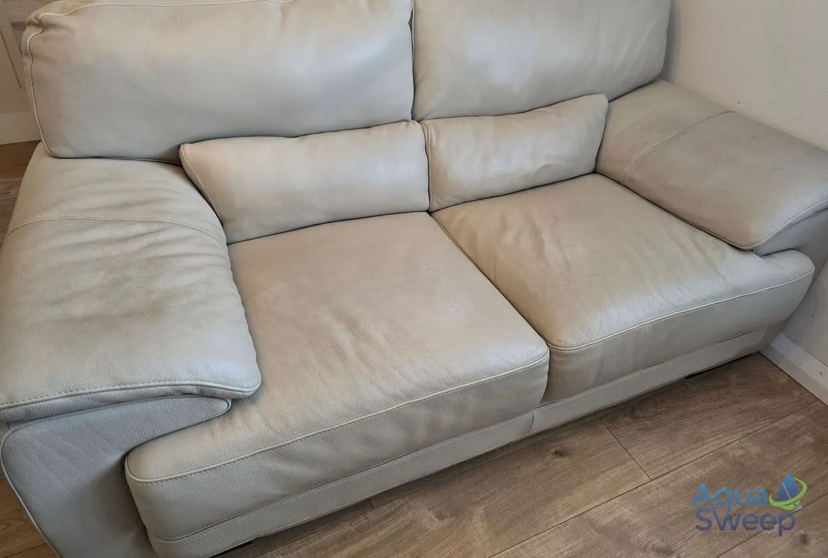 Before: cream leather two seater sofa