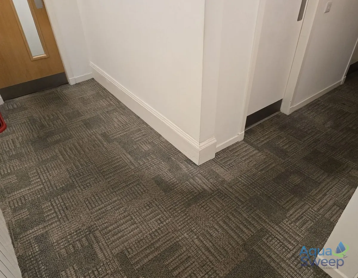Before: office carpet tiles in a corridor corner, darkened by foot traffic