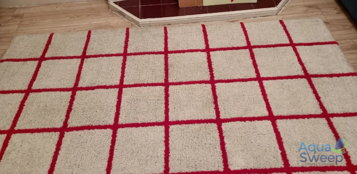 After: cream shaggy rug with a red grid pattern