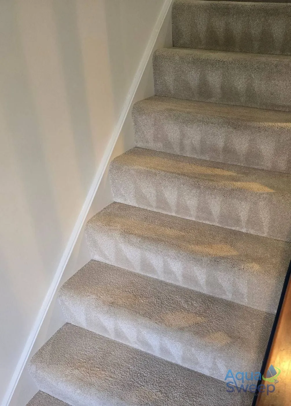 After: light carpeted staircase with dark marks on every step