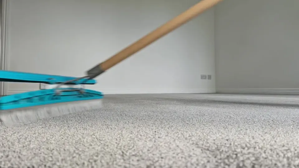 Carpet rake grooming the pile of a light carpet after cleaning