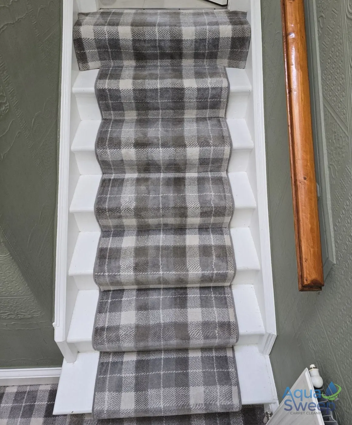 After: tartan stair runner on a white staircase, dull with dirt