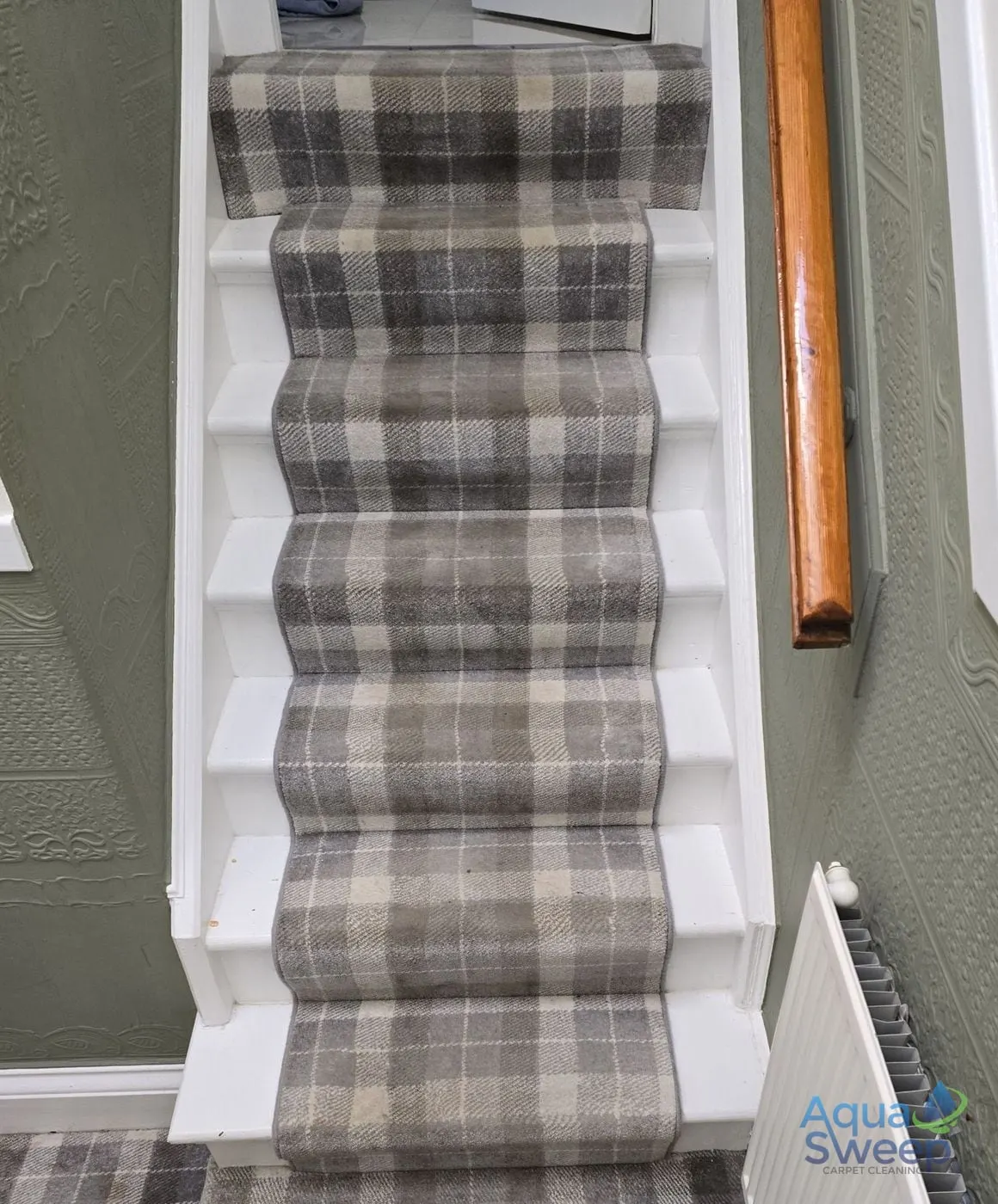 Before: tartan stair runner on a white staircase, dull with dirt